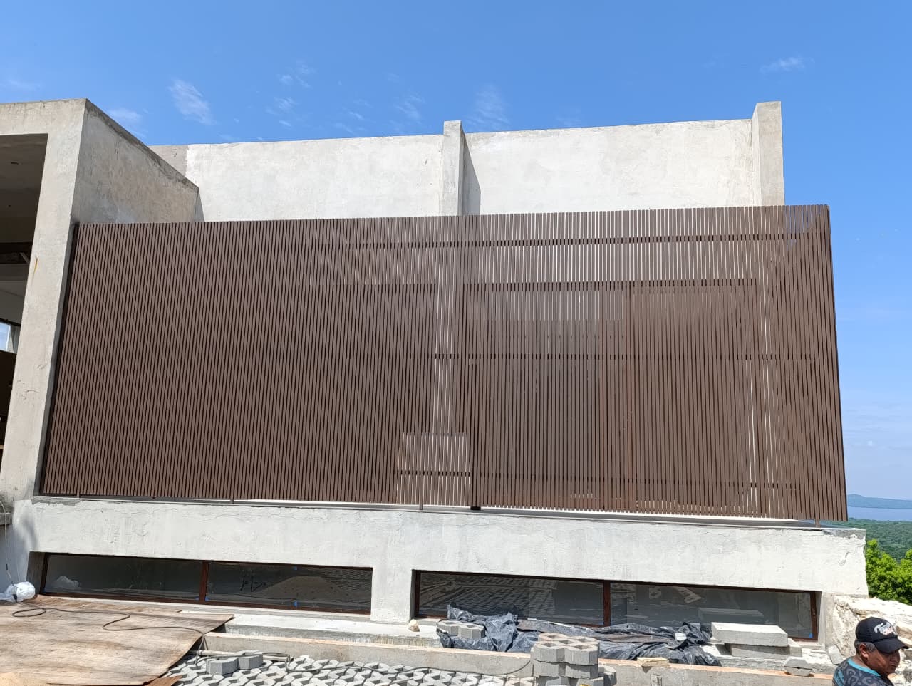 Worker in safety gear grinds metal, creating sparks, showcasing craftsmanship at metal workshop.