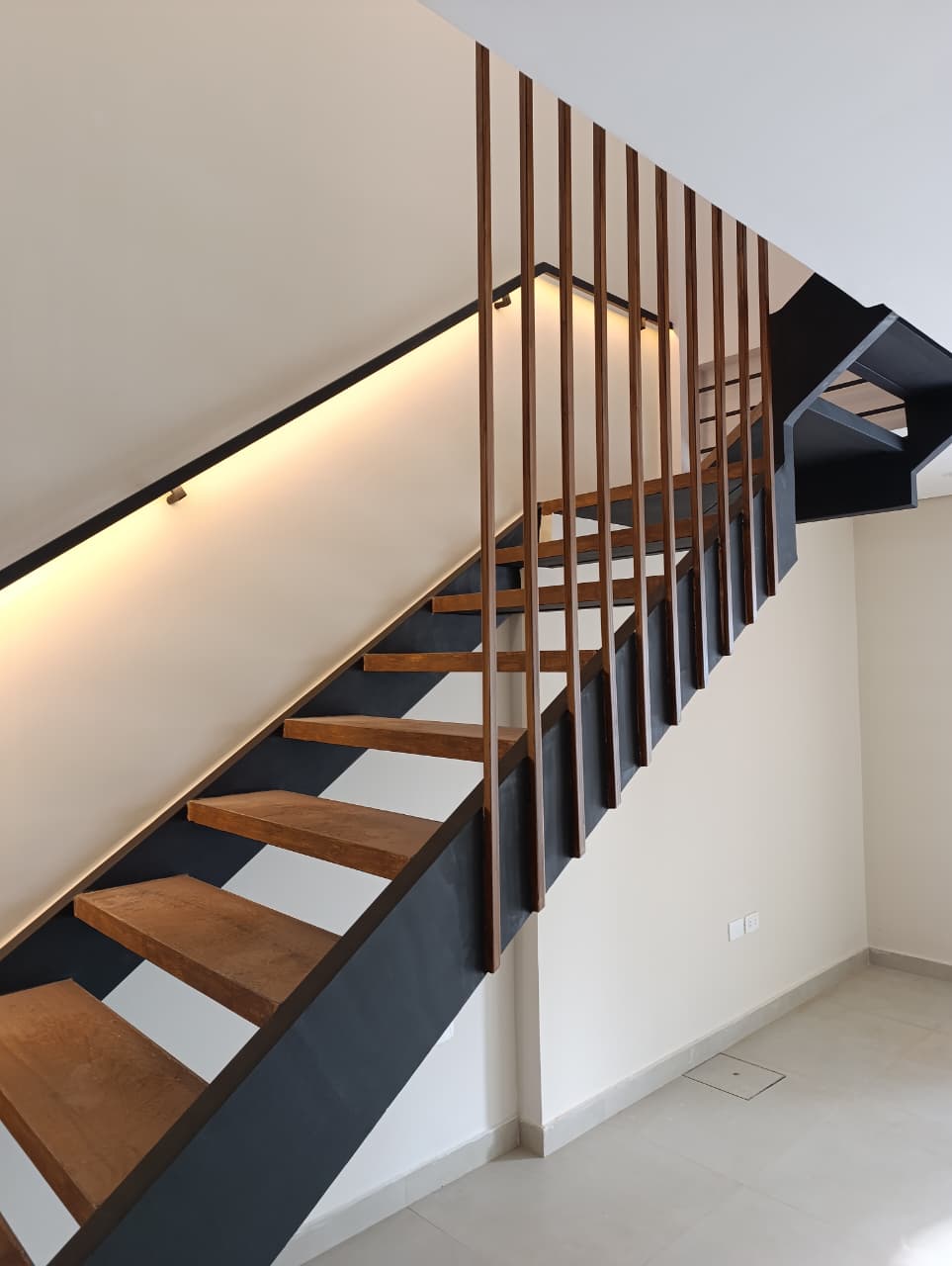 skilled worker cutting an iron pipe with a grinder at vertical composition