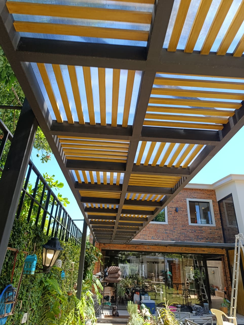 Man in protective gear working with grinder tool, creating sparks, inside factory.