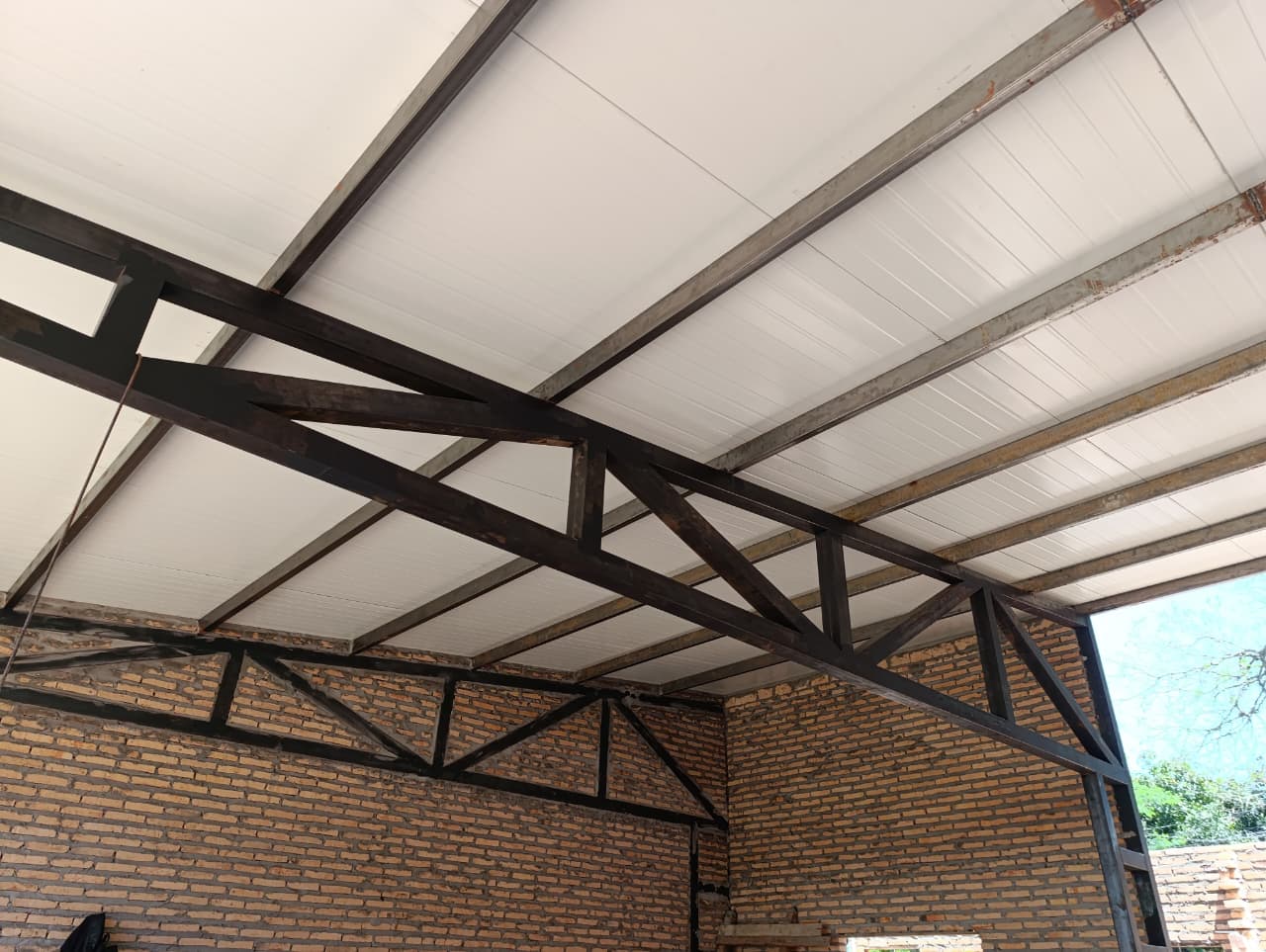 Sheet metal bending on CNC machine. Gloved worker bending a metal sheet using a CNC press brake in an industrial setting focused on precision manufacturing