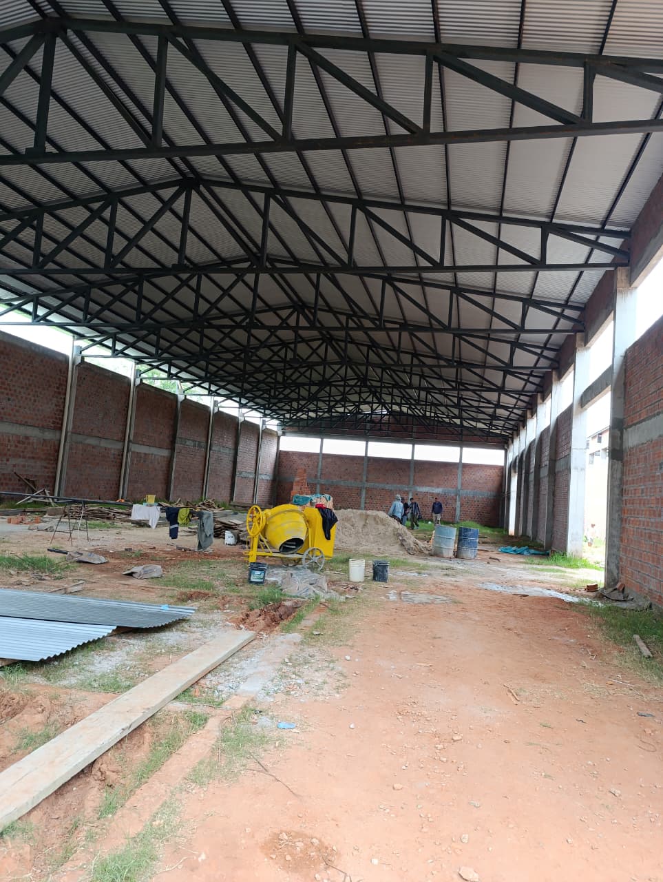 Two factory workers assembling aluminum and PVC window frames in a modern window manufacturing plant