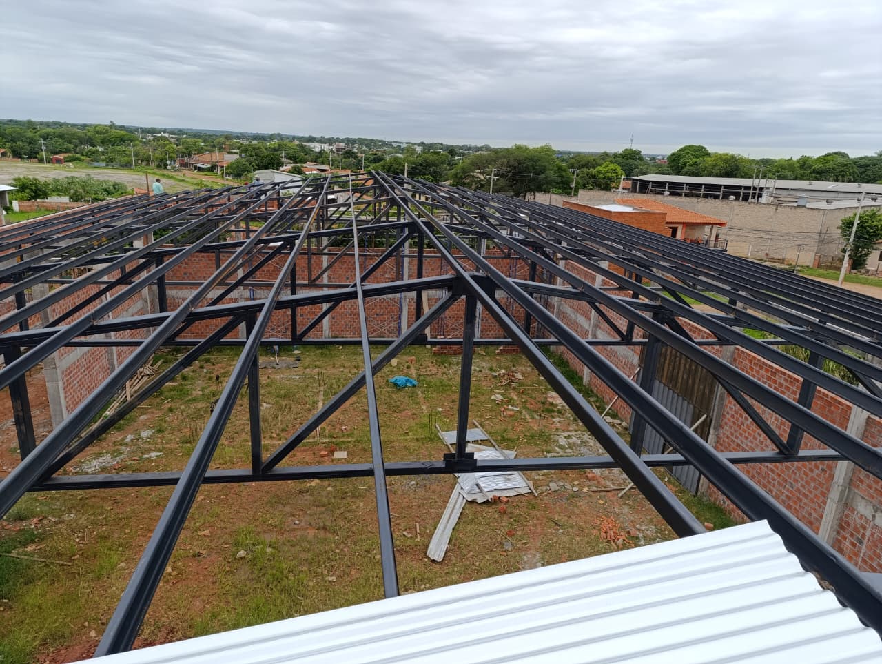 Two factory workers assembling aluminum and PVC window frames in a modern window manufacturing plant