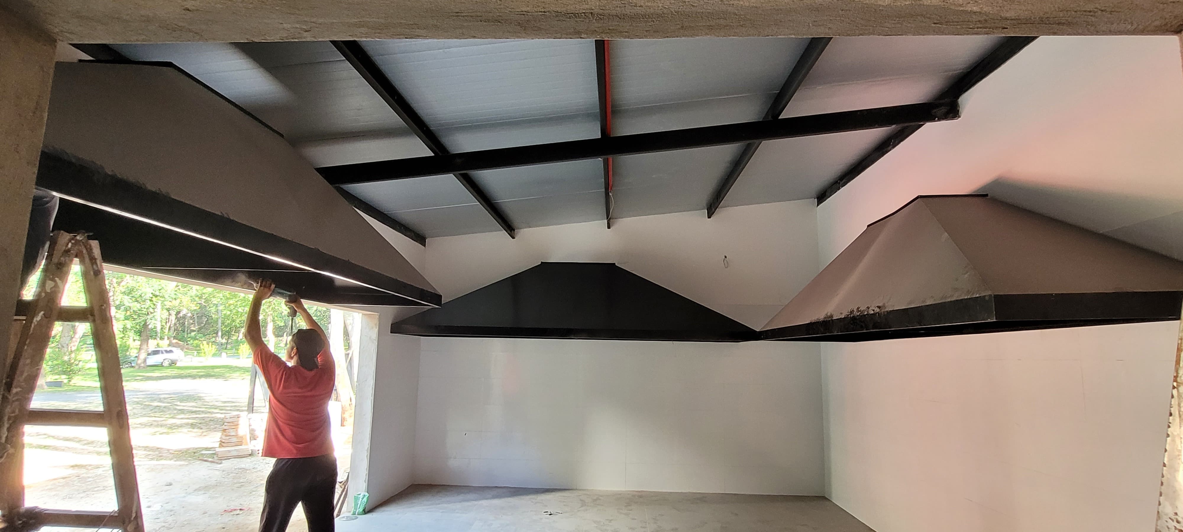 Two factory workers assembling aluminum and PVC window frames in a modern window manufacturing plant